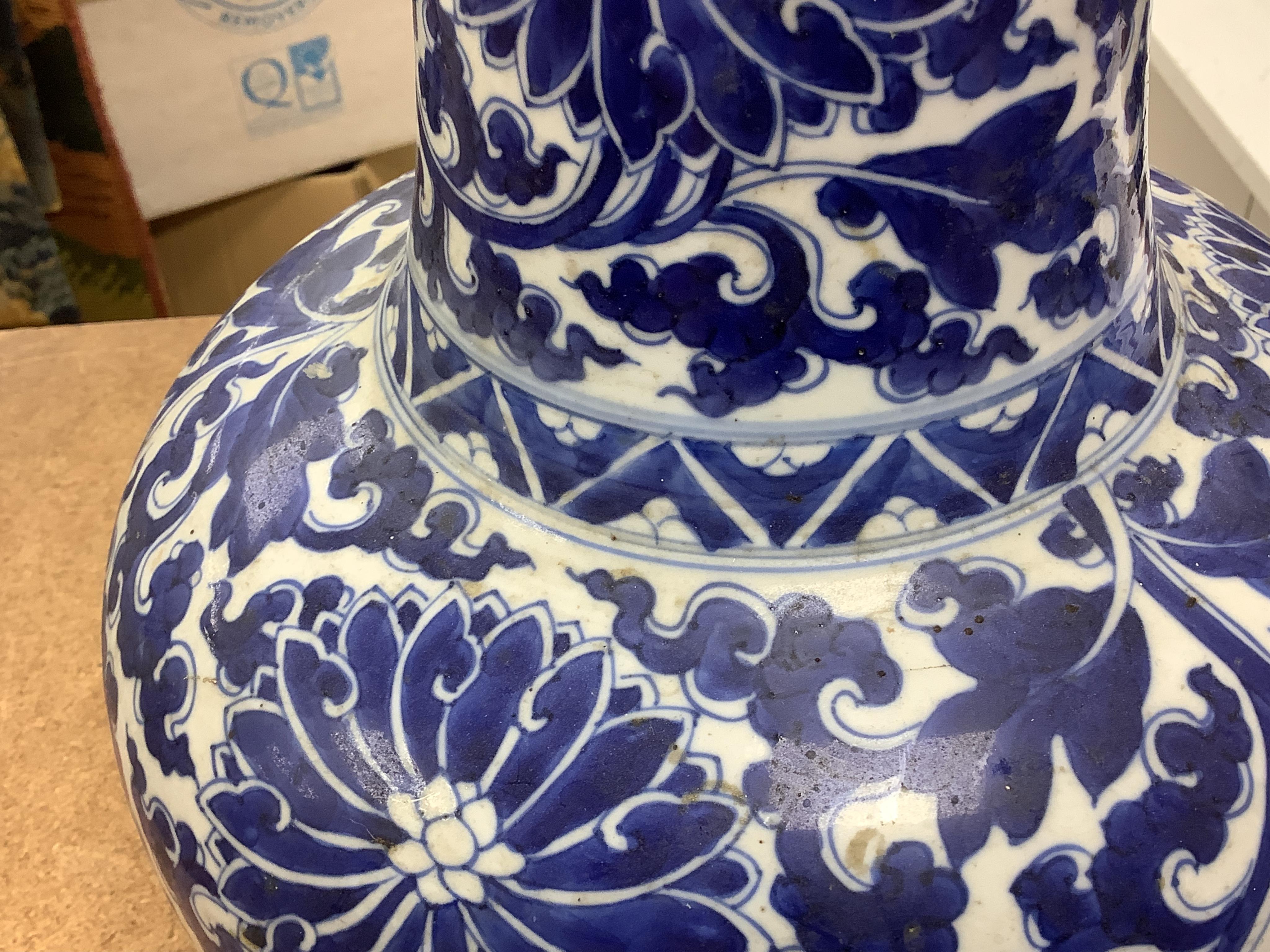 A Chinese blue and white bottle vase with lotus decoration, restored, Kangxi Period, 44cm high